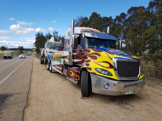 towing trucks parked in the side highway